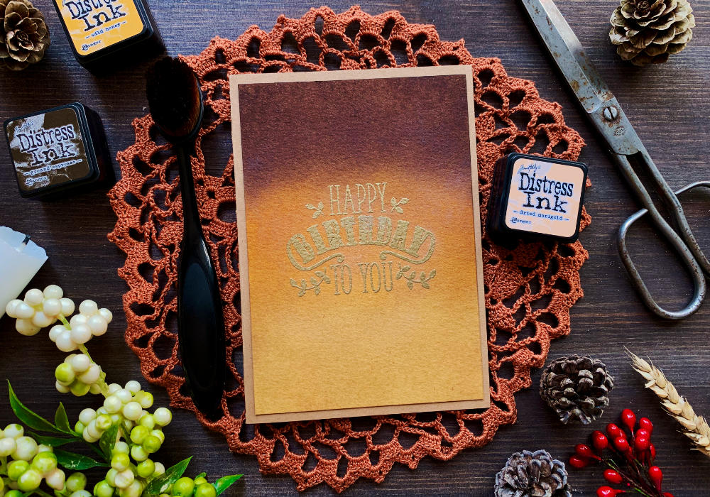 Happy Birthday handmade greeting card with an ink blended background using earthy colours - dark brown, orange and dark yellow. The greeting says Happy Birthday To You and is heat embossed in gold.