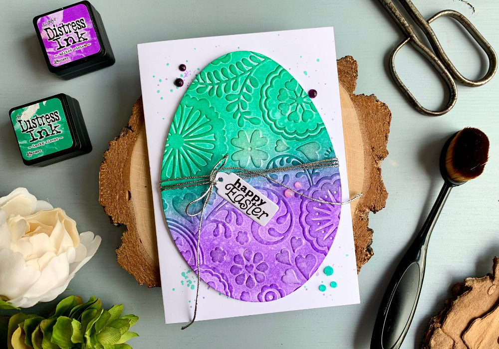 Make a beautiful yet very simple Easter card with a big decorated egg using a egg die, embossing folder and Distress inks.
