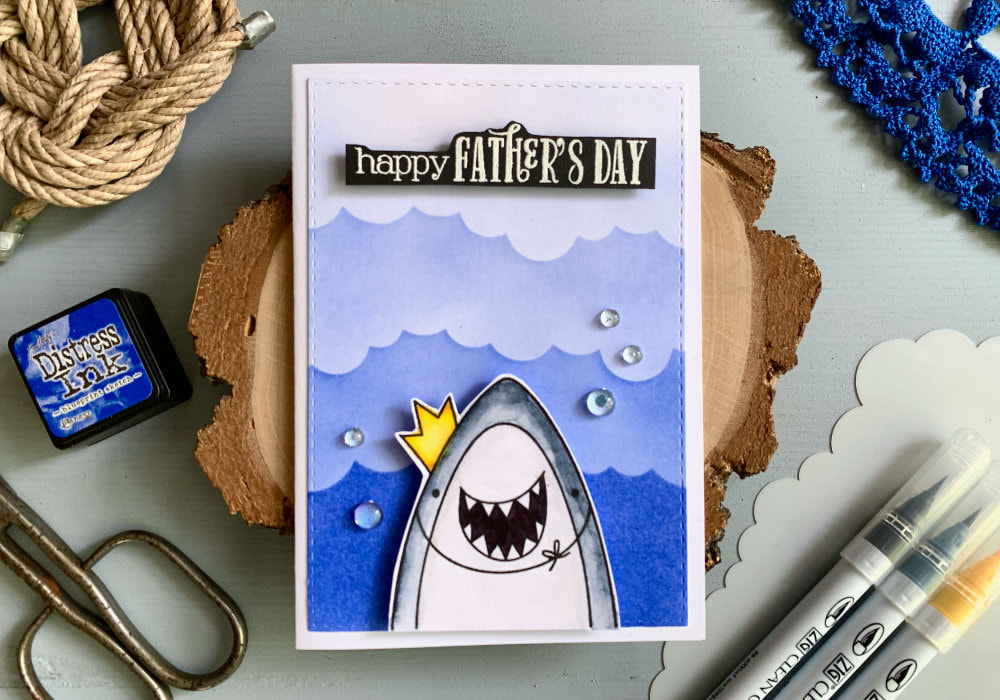 Fun and simple card for Father's day using a cute stamp set with a shark from the stamp set Sea-Prise! by Avery Elle and background with waves created with a cloud stencil and Distress inks.