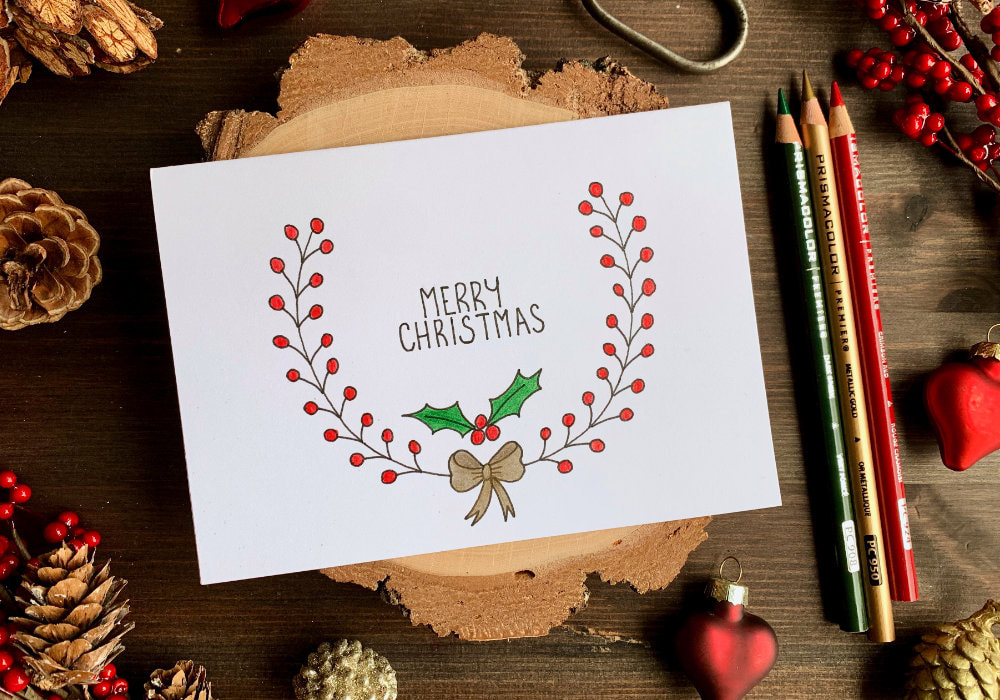 A Simple handmade Christmas card with a quick and easy hand-drawn Christmas wreath for which I used a black fine-liner and coloured with colouring pencils Includes a free printable.
