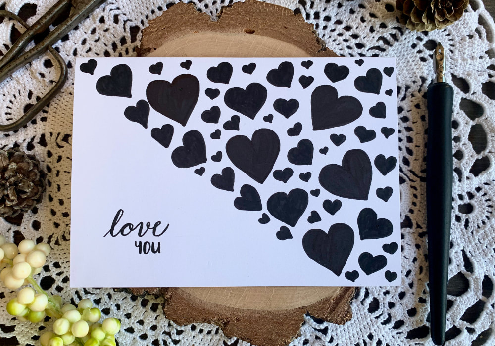 Quick and simple black and white DIY Valentine's card, made with minimal supplies. All you need is a black marker like Sharpie and a white card base.