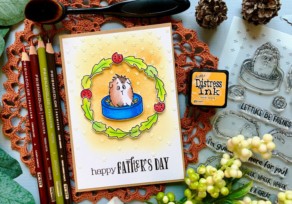 Fun masculine card for Father's Day, creating a wreath with tiny leaf and tomato stamps and guinea pig in the middle, with a yellow background covered with stars created with a stencil and embossing paste.