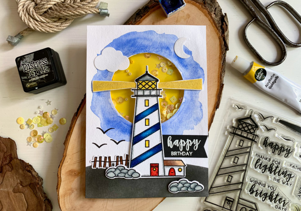 Fun masculine mixed media shaker card with a lighthouse, created using the stamp set Shine Bright by Avery Elle and multiple colouring products, such as colouring pencils, inks, watercolours, acrylic paints and a Distress ink. Perfect card not only for Birthday or Father's Day.
