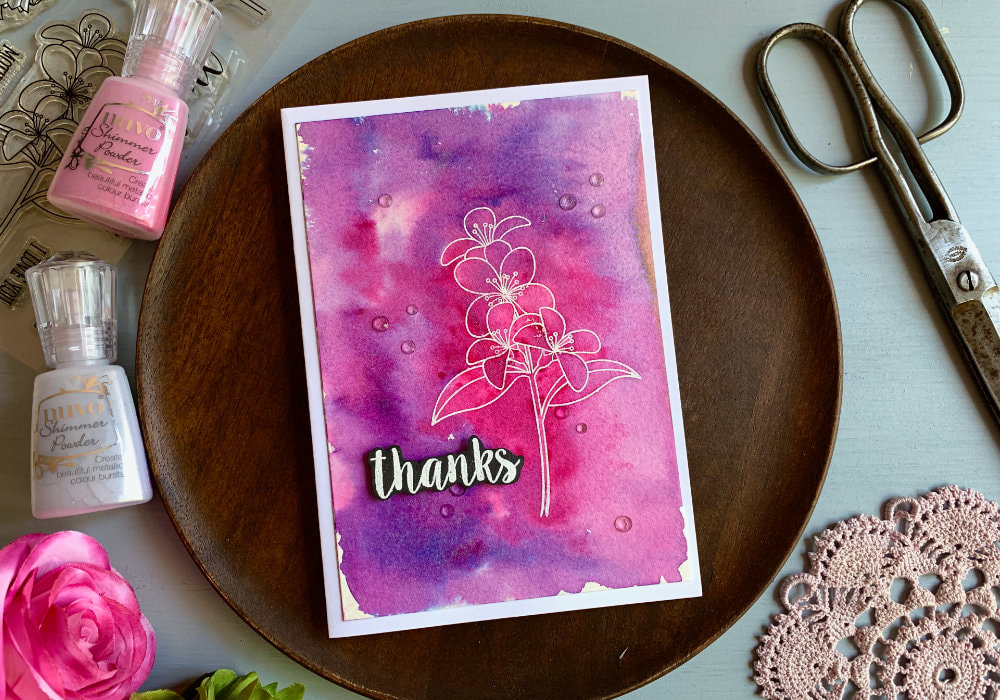 Simple handmade Thank you card with a flower stamped and heat embossed in white and background created using the Nuvo Shimmer Powders - Cherry Bomb  and  Violet Brocade.
