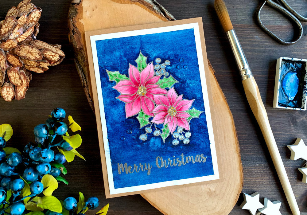 Handmade Christmas card & phone case insert with a stamped and heat embossed poinsettia, painted with pink watercolours and background painted using very dark blue. The greeting says Merry Christmas and is also stamped and heat embossed using a metallic platinum embossing powder.
