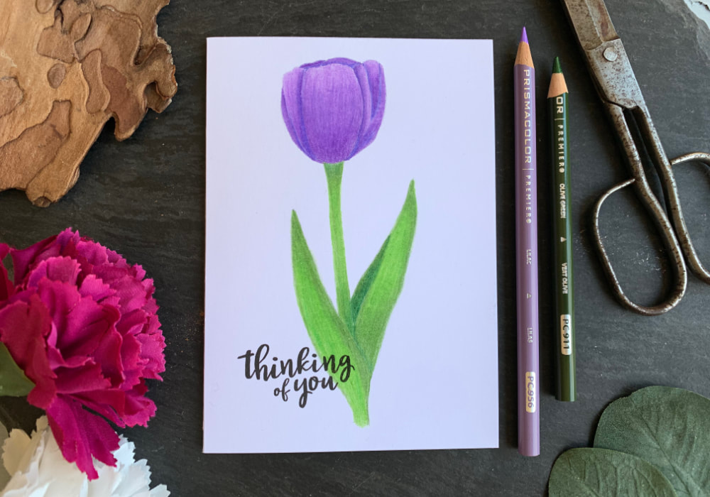 Handmade card with a single hand drawn purple tulip, coloured with Prisma pencils. Perfect card idea for Mother's Day.
