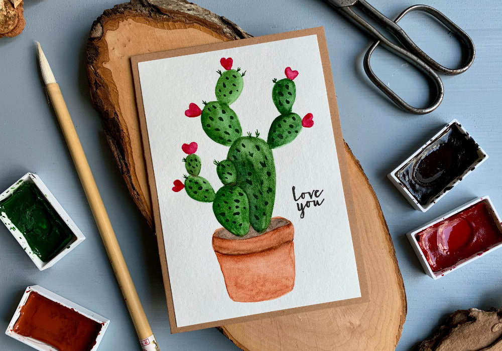 Handmade Valentine's day and anniversary greeting card with hand painted cactus and pink hearts instead of flowers. The greeting is stamped and says Love You.