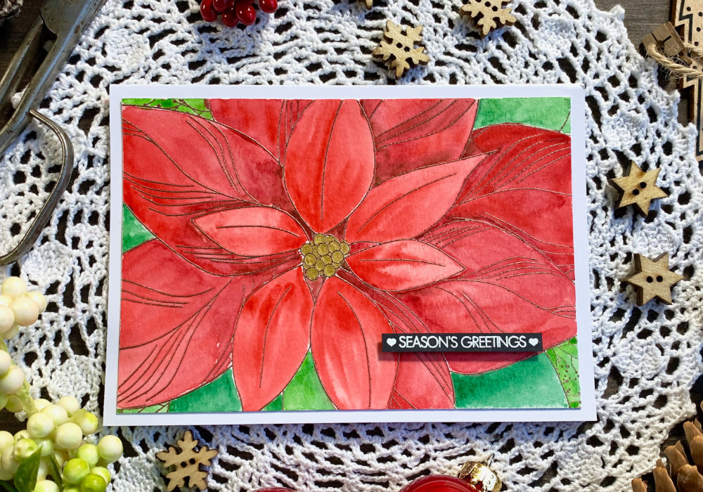 Handmade Christmas card using a big background stamp called Poinsettia Close Up by The Ton and heat embossing it and then colouring it with watercolours.