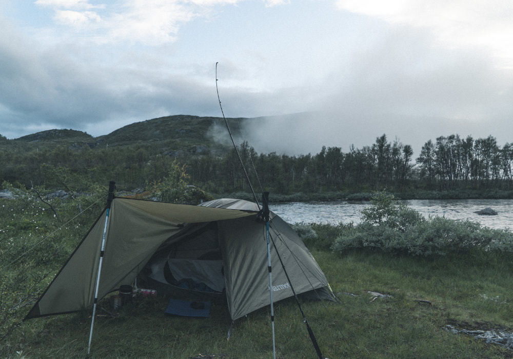 Last camp with our tent next to a river during a misty morning in Harndangervidda in Norway.