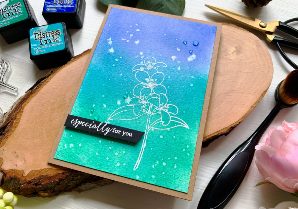 Make a quick and easy cards with some cool Distress ink blends, here I used Blueprint Sketch, Peacock Feathers and Lucky Clover. After sprinkling little bit of water over the panel and waiting till it's fully dry, I stamped a flower and heat embossed it using a white embossing powder. 