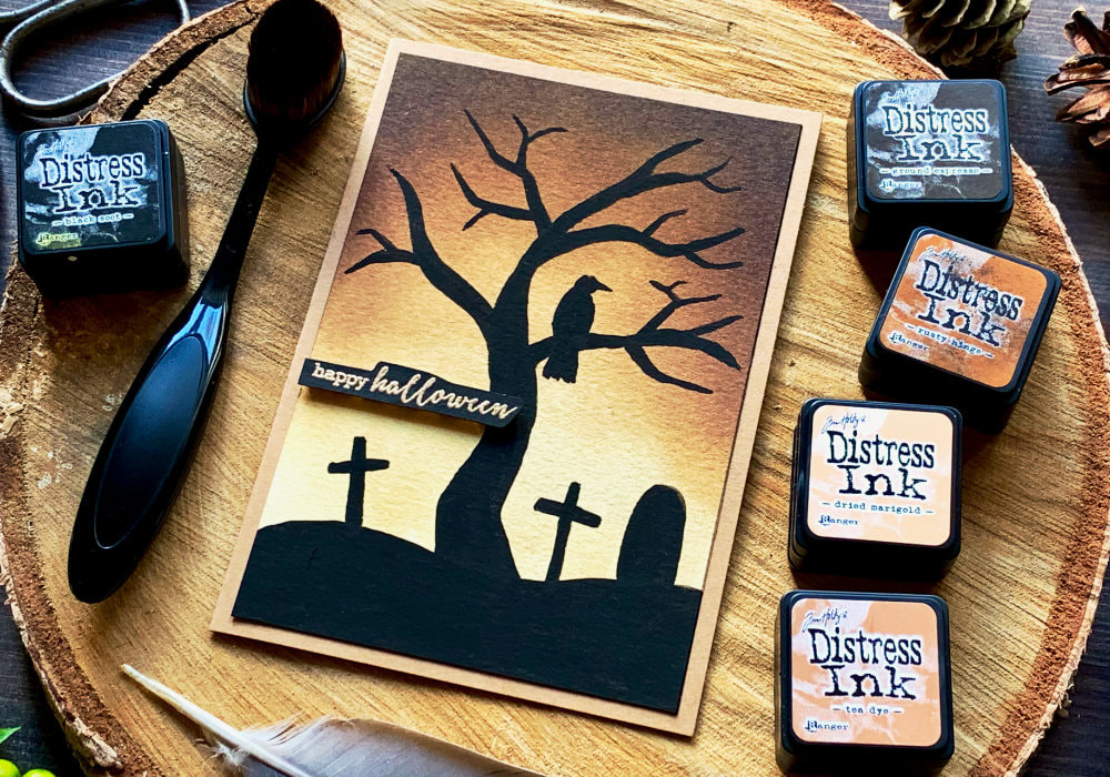 Halloween card with a brown Distress ink background and a black tree silhouette, a raven and a grave yard using gouache.