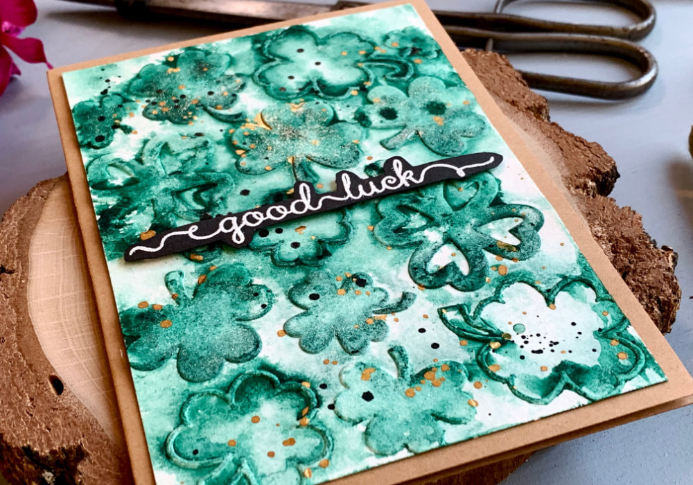 Handmade greeting card  for St. Patrick's with Good Luck greeting and background with clovers created with embossing folder. To make the embossed clovers green I added green watercolour into the wells of the embossing folder.