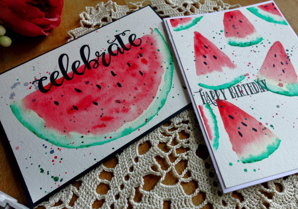 Photo of two handmade cards with a watercoloured watermelon. One with half a slice, the other with a background with quarter slices.