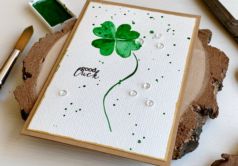 Handmade card for St. Patrick's day with a green watercolour lucky clover and a Good Luck greeting stamped in black.