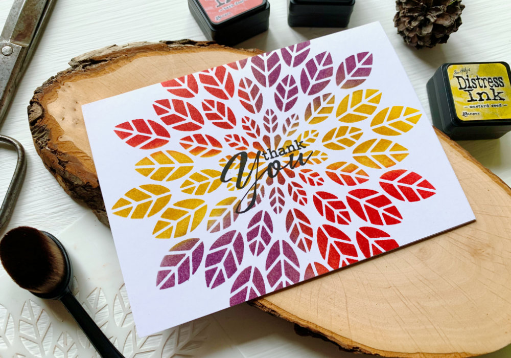 Make a simple handmade Thank You card and creating a quick Distress ink blending combination using the inks Mustard Seed, Barn Door and Dusty Concord together with the Leaf Burst stencil by Altenew. 