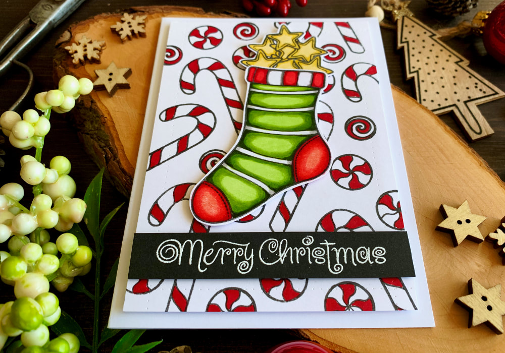 Handmade Christmas And Holiday card with a stamped and die-cut Christmas stocking filled with stars and stamped background filled with candy canes, coloured with alcohol markers from Altenew.