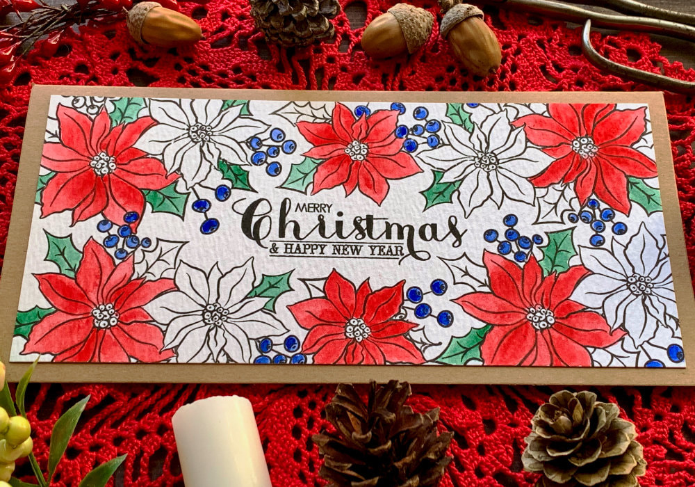 Handmade Christmas card with poinsettia flower  that are stamped along the edges of the card stock creating a frame. The stamp set used is the Holiday Bouquet stamp set by Avery Elle. Some of the flowers are coloured with watercolours some are black and white and the sentiment says Merry Christmas.