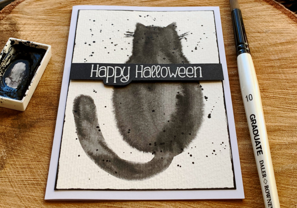 Paint a very simple black cat using watercolours and the wet on wet technique and creating a quick and easy DIY Halloween card.