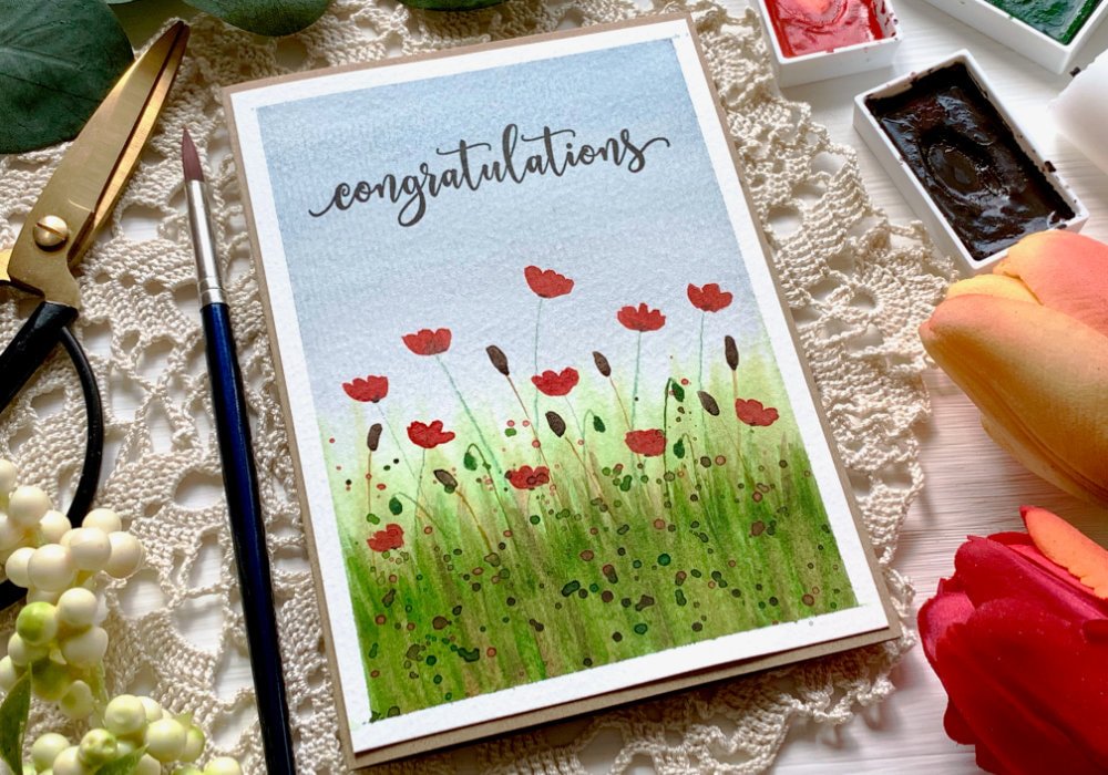 Learn to paint a poppy field using watercolours and create a handmade card. Watercolour poppy field tutorial for beginners.