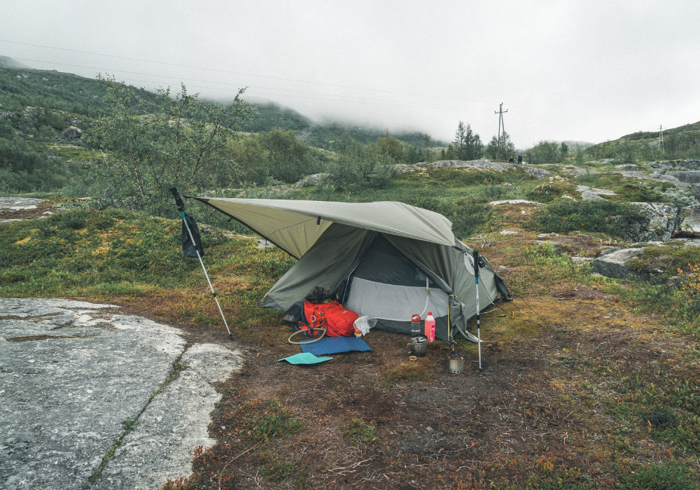 Tent camp set up in Hardangervidda Norway during a gloomy and misty day.