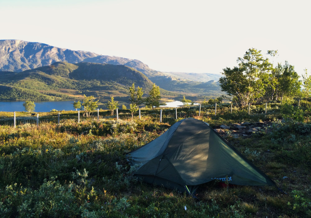Photo of our tent with a view of mountains in the Jotunheimen National Park in Norway.