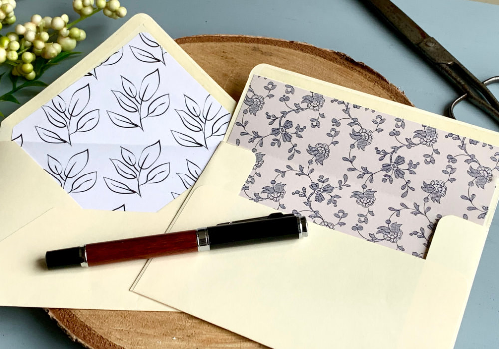 Two handmade envelopes created from scratch using basic tools and decorated with envelope liners.