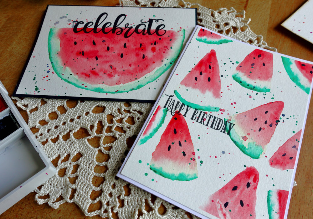 Photo of two handmade cards with a watercoloured watermelon. One with half a slice, the other with a background with quarter slices.
