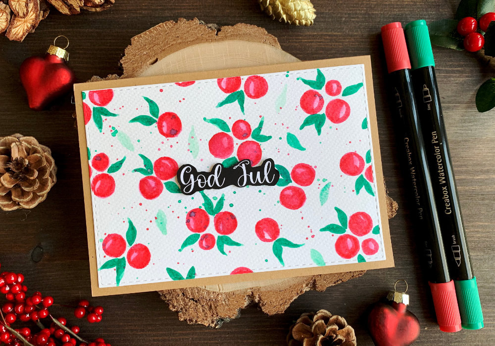 Handmade Christmas card with painted winter berry background using cheap watercolour supplies from Lidl.   