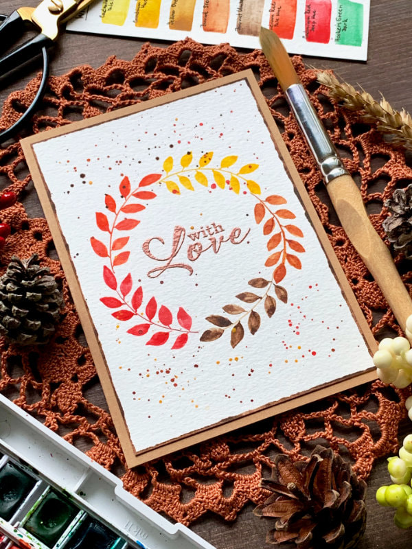 Handmade budget friendly card with a very simple watercolour wreath in autumnal colours.