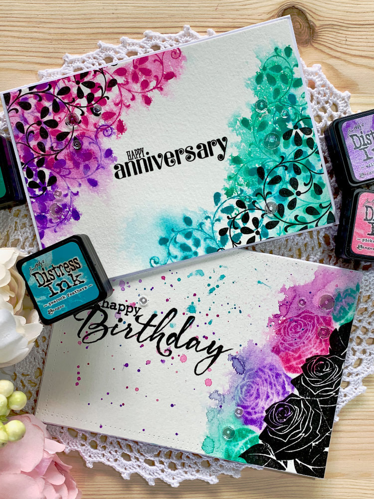 Handmade cards using solid stamps with leafs and roses and stamping with black inks and distress inks in pink, purple, blue and green colours, and reactivating the distress inks to create a messy watercolour look.