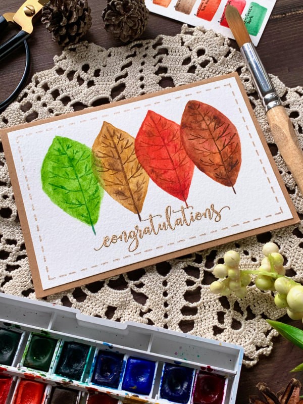 Make a simple handmade card with painted leafs in autumnal colours using watercolours. This is a very easy budged and beginner friendly card.