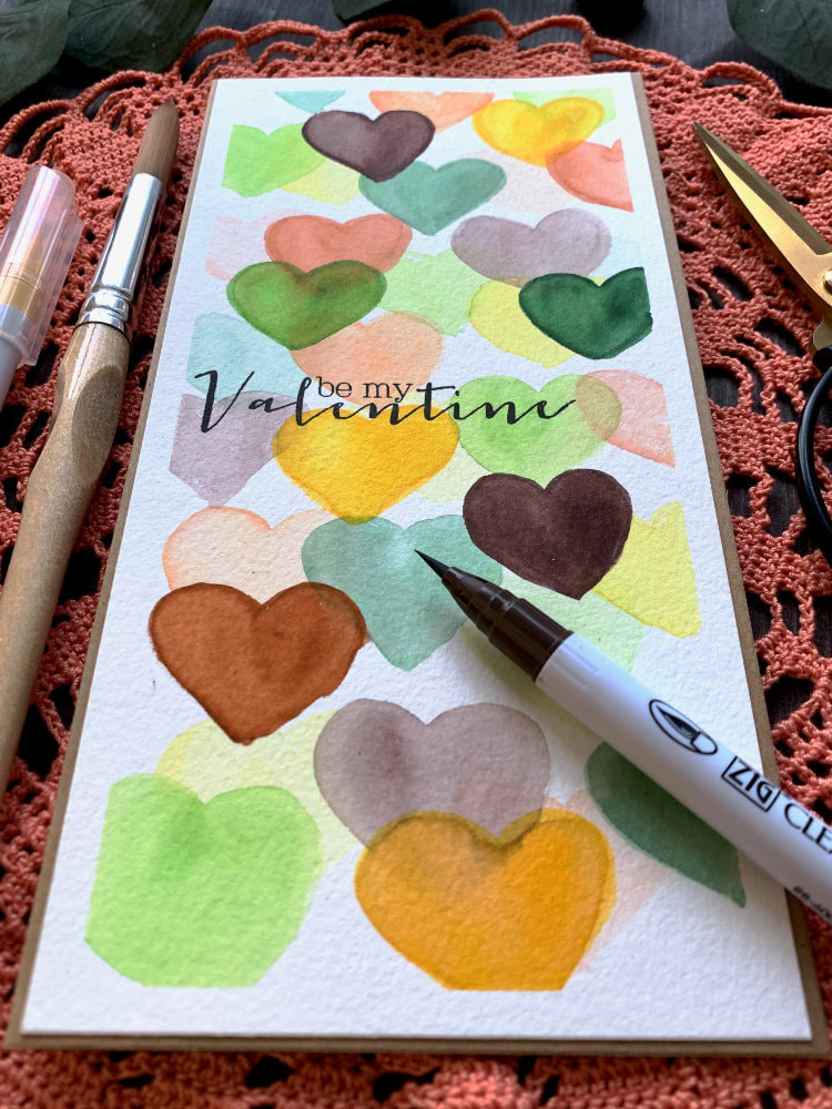 Watercolouring a very simple DIY handmade card for Valentine's Day without any stamps or dies, using a layering technique and making a beautiful background filled with hearts in the colours greens, yellows and browns.
