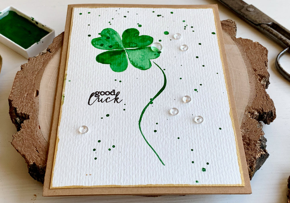 Handmade card for St. Patrick's day with a green watercolour lucky clover and a Good Luck greeting stamped in black.