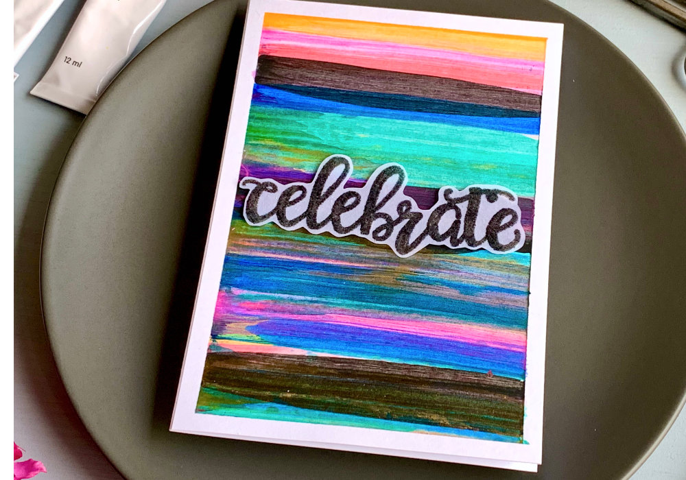 Handmade greetIng card with a colourful background filled with stripes in various colours - pink, blue green, black as well as gold and silver. The background was created with acrylic paints and squeegee.