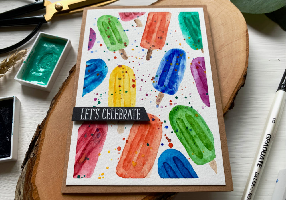 Handmade card with a background filled with ice lollies in the colours of rainbow.
