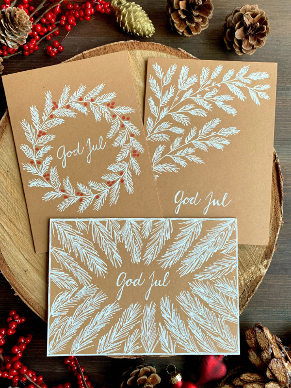 Handmade Christmas greeting cards with hand-drawn fir tree branches using only a white gel pen and a blank card.