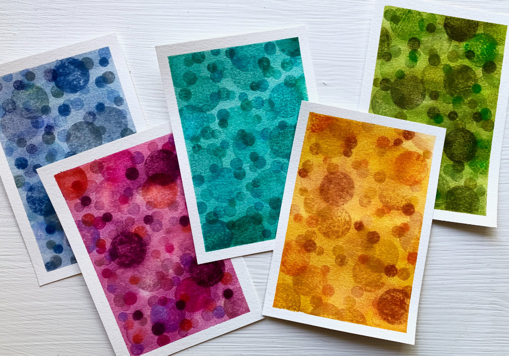 Create a handmade card with a beautiful and colourful background with circle stamps and stamping them using Distress inks and reactivating the inks with water to create a background with a soft bokeh effect. Perfect for Father's day cards or other cards for men.