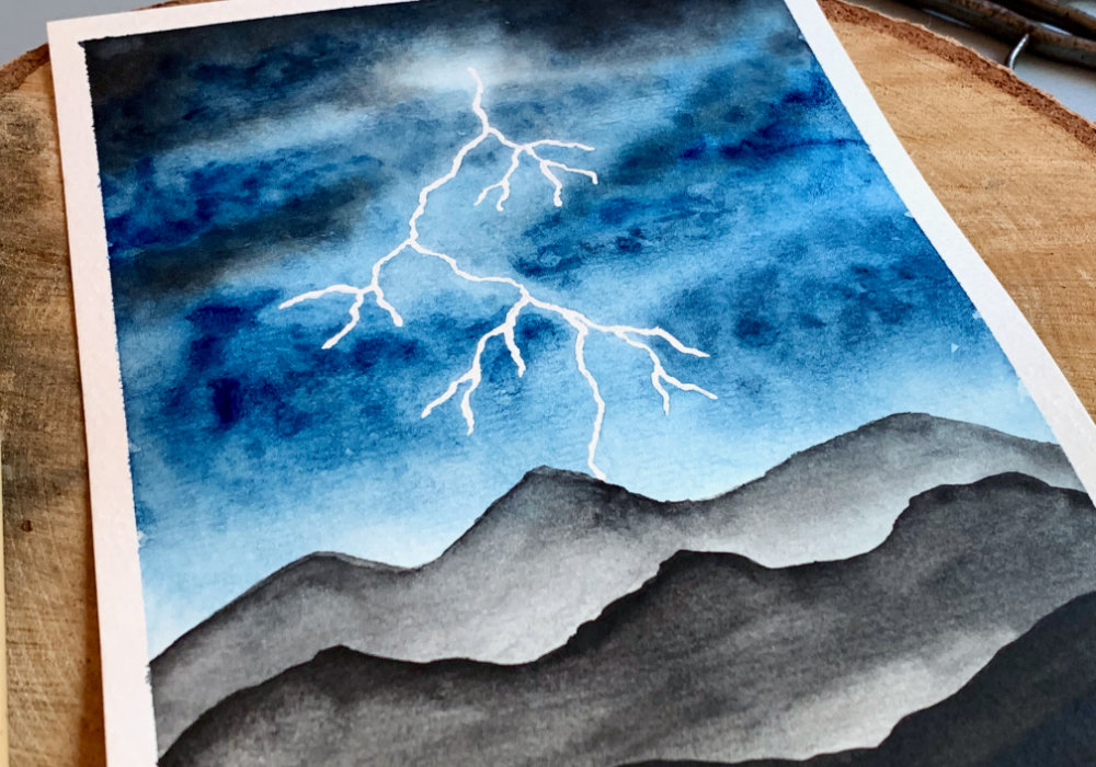 Watercolour painting of a landscape with a dark blue stormy sky and lightning hitting mountains.