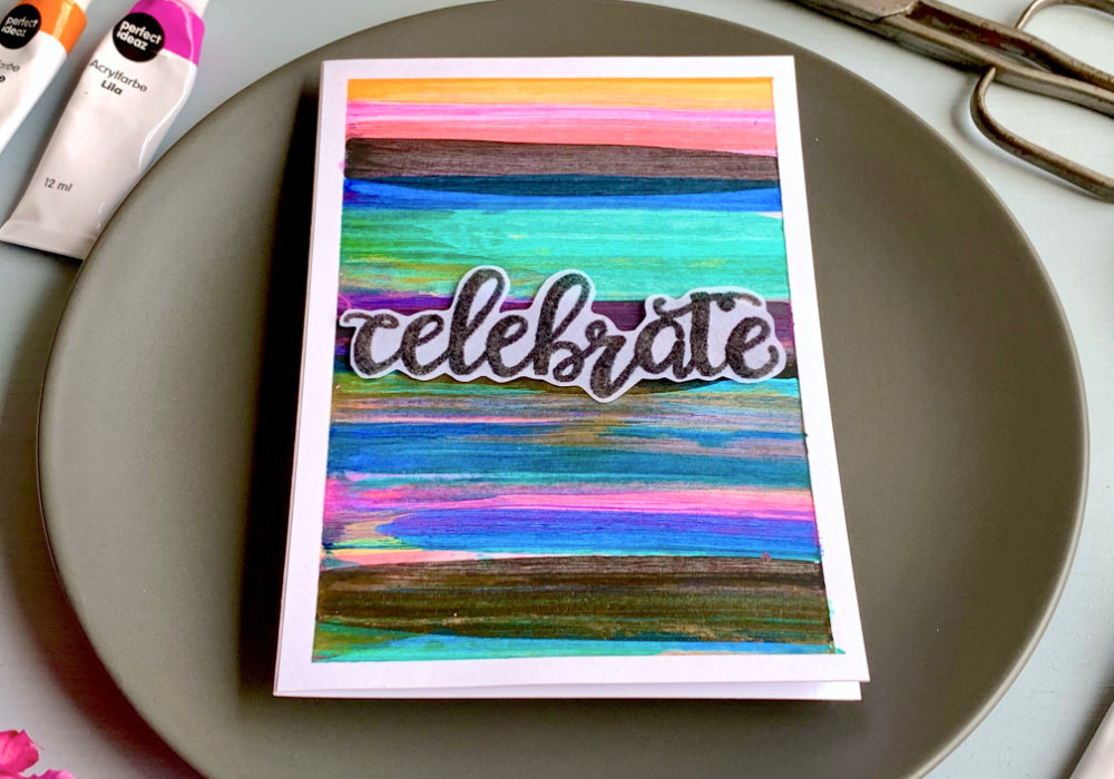 Handmade greetIng card with a colourful background filled with stripes in various colours - pink, blue green, black as well as gold and silver. The background was created with acrylic paints and squeegee.