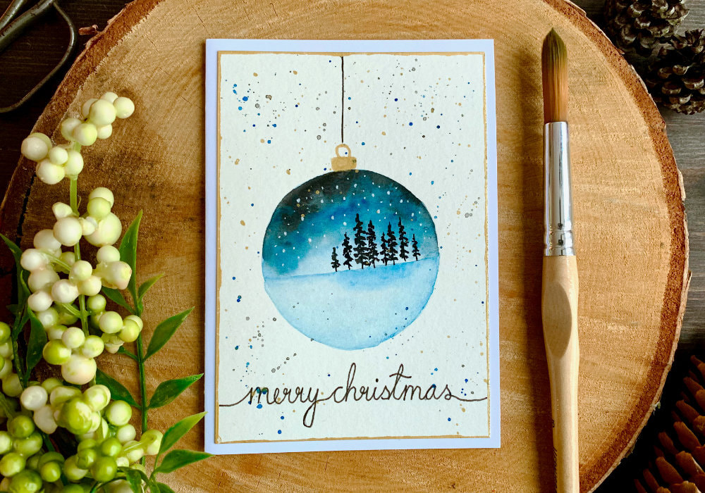 Beginner watercolour painting tutorial. Learn how to paint a very simple Christmas ornament decoration with a landscape.
Here I have for you two cards, one with a snowy night sky and tries and the other with mountains during sunset.