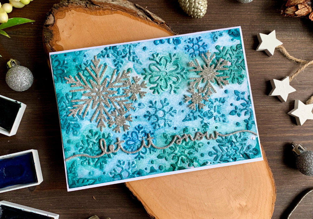 Handmade sparkly Christmas cards with an embossed snowflake background doing an embossing folder watercolour technique using Nuvo Shimmer powders, regular watercolours as well as Distress ink pads.