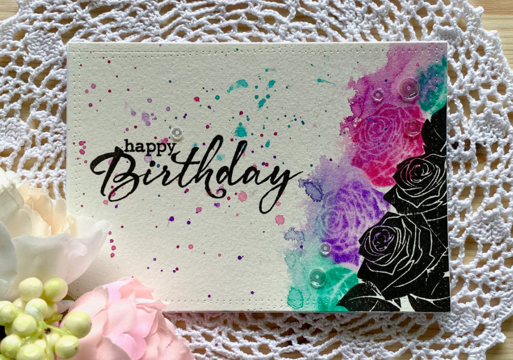 Handmade Birhtday card using solid stamps with roses and stamping with black inks and distress inks and reactivating the distress inks to create a messy watercolour look.