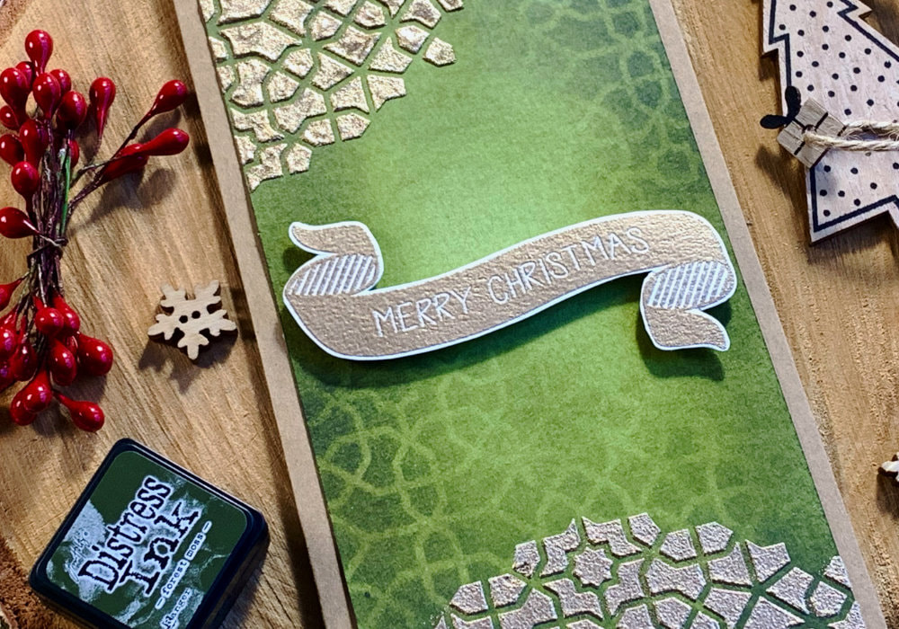 Handmade Christmas card with a green background using Distress inks with beautiful mandala made by using a stencil and creating a tone on tone blending as well as using embossing paste with embossing powder to create a golden mandala pattern.