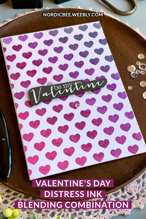 Simple handmade card for Valentine's day with a purple Distress ink bending combination using the inks Faded Jeans, Wilted Violet, Seedless Preserves and Picked Raspberry, blended over a stencil with hearts. 