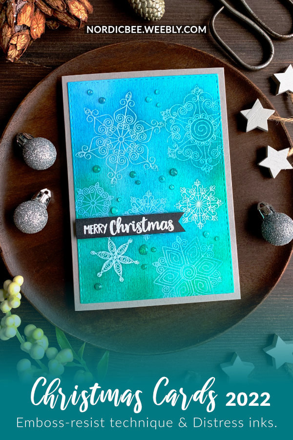 Handmade Christmas card with a simple winter Distress ink blending colour combination, doing the emboss-resist technique using snowflakes and clear embossing powder.