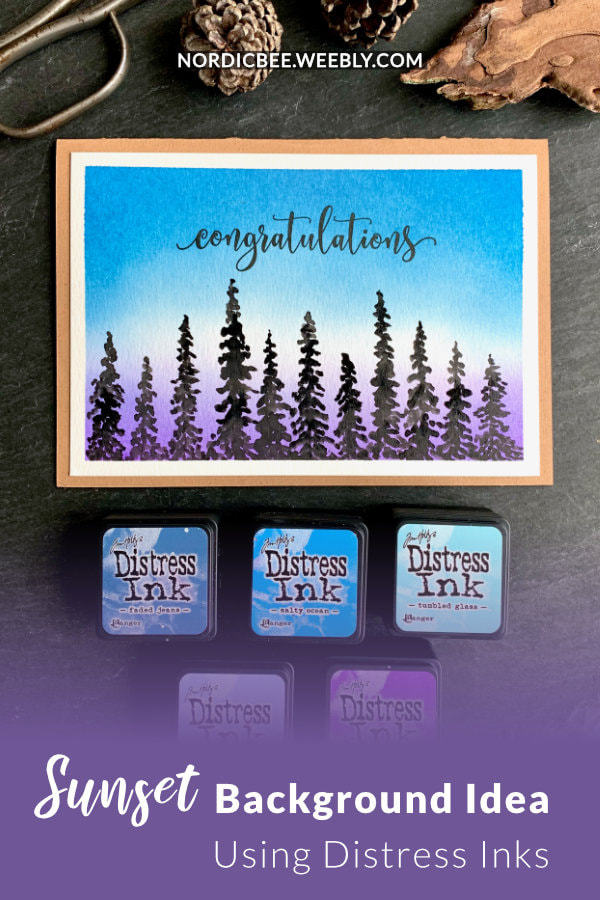Make a simple DIY card with a background of a sunset or sunrise created by blending Distress inks - Faded Jeans, Salty Ocean, Tumbled Glass, Shaded Lilac and Wilted Violet and painting pine trees across the bottom.