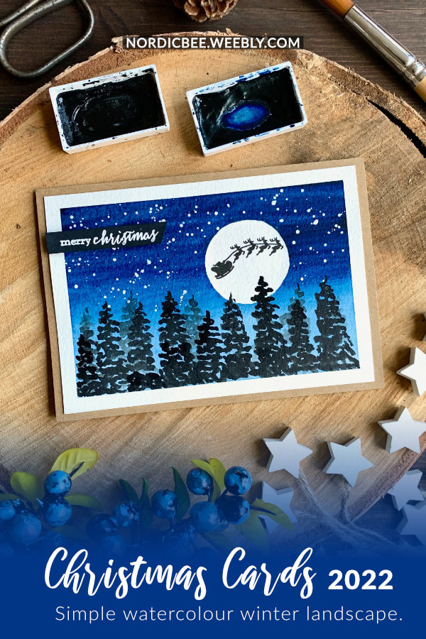 Simple  winter landscape Christmas card with a dark blue night sky and snow, moon with stamped silhouette of Santa's sleigh and reindeers and silhouettes of fir trees. 